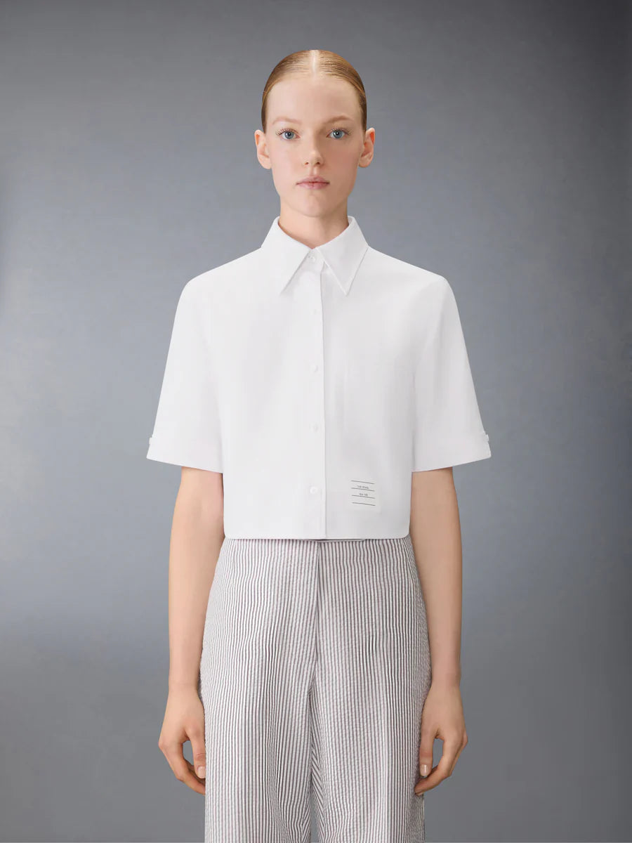 Thom Browne light blue Oxford cropped short sleeve button-down shirt with chest pocket and signature woven label patch