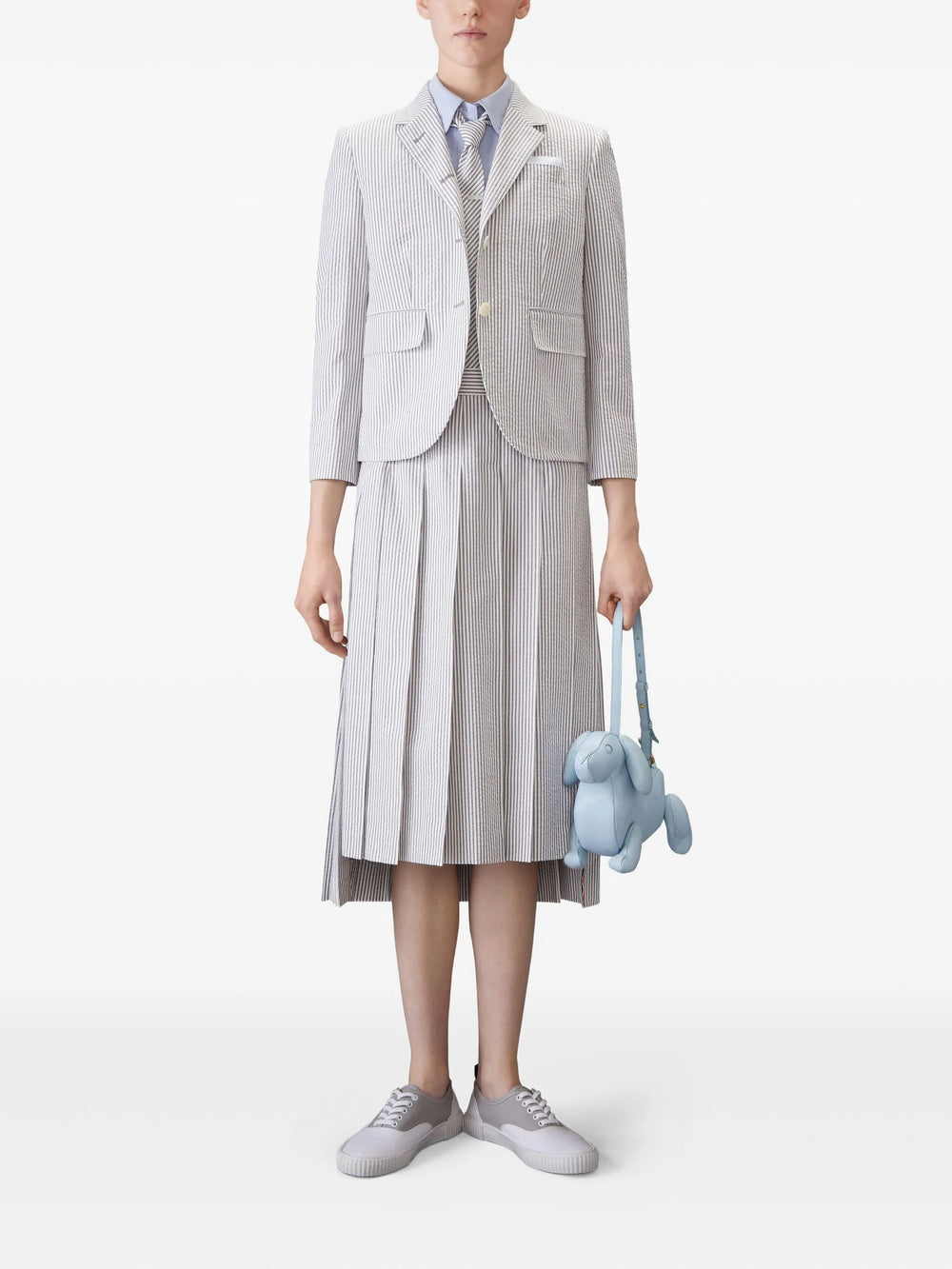 Thom Browne light blue oxford short sleeve shirt with rounded collar and signature woven label at hem, front view