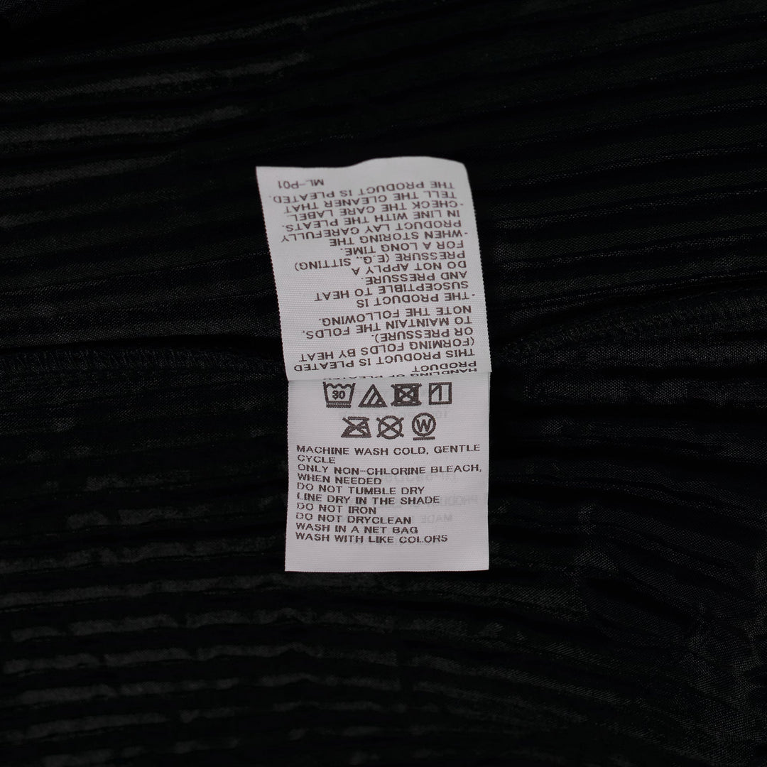 Homme Plissé Issey Miyake Basics Jacket in black — front view showing signature pleated fabric, notch lapel, and single-button closure