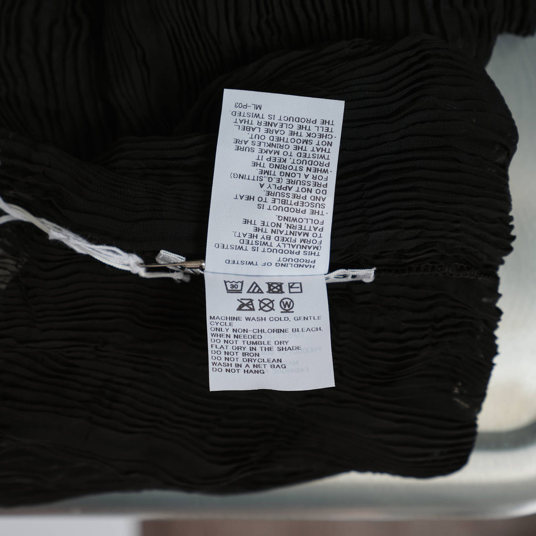 Issey Miyake Chiffon Twist Woven Top in black, featuring semi-sheer rippled pleated texture, high turtleneck collar and long sleeves, displayed on a form