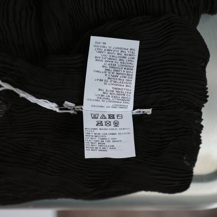 Issey Miyake Chiffon Twist Woven Top in black, featuring semi-sheer rippled pleated texture, high turtleneck collar and long sleeves, displayed on a form