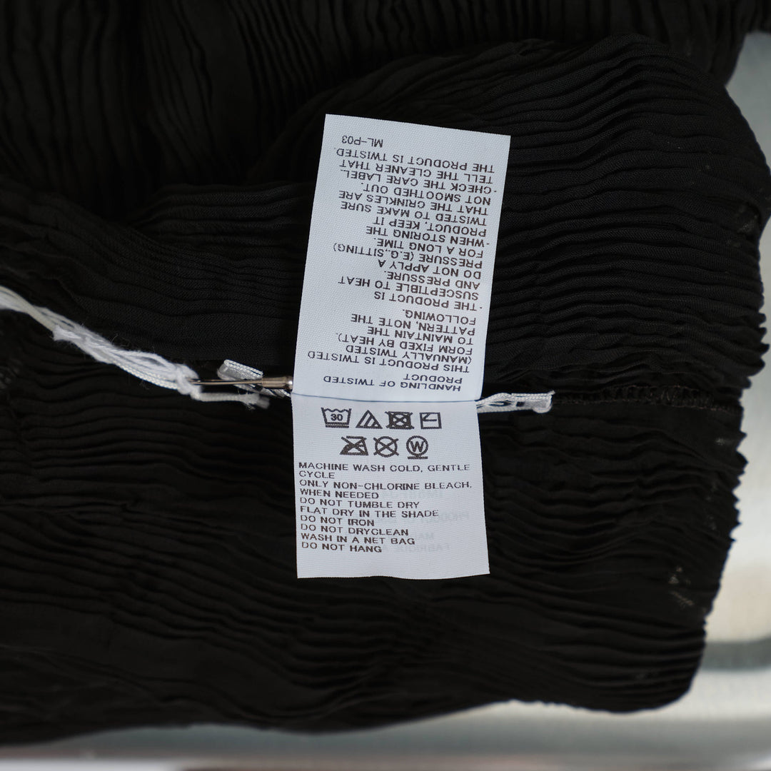 Issey Miyake black chiffon twist woven top with vertical wave pleating, mock turtleneck, and short sleeves on a mannequin torso