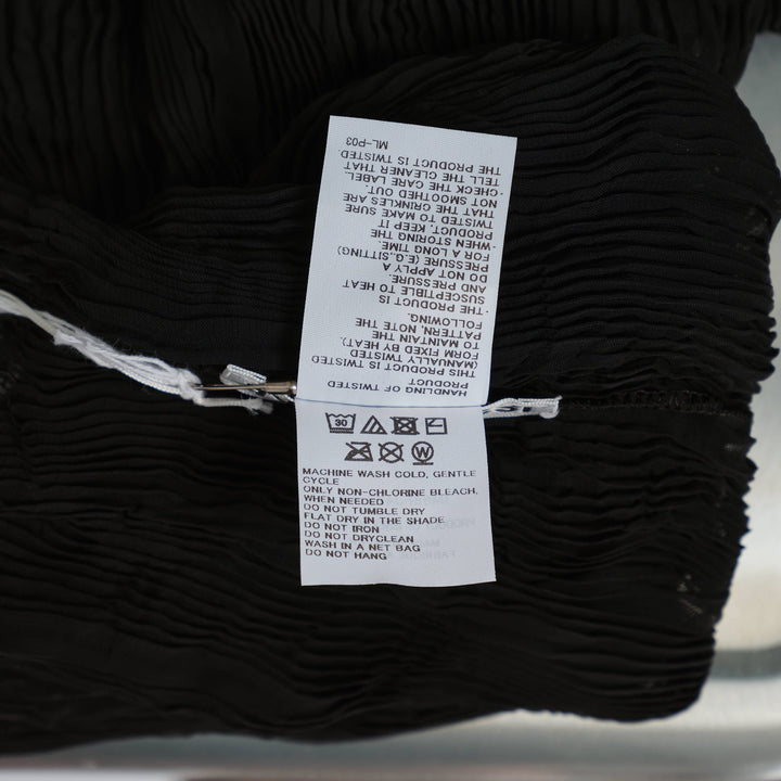 Issey Miyake black chiffon twist woven top with vertical wave pleating, mock turtleneck, and short sleeves on a mannequin torso