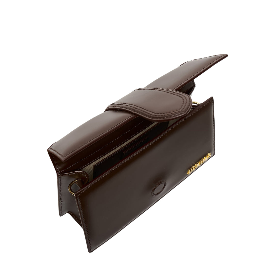 Jacquemus Le Grand Bambino smooth dark brown leather shoulder bag with adjustable crossbody strap, curved top handle, central flap tab closure, and gold-tone hardware and branding - view 3