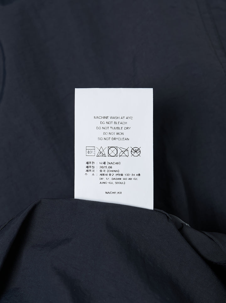 Dark navy wide-leg Nache nylon pants with a drawstring waist and ruched, pintucked hems, shown from the front - view 3
