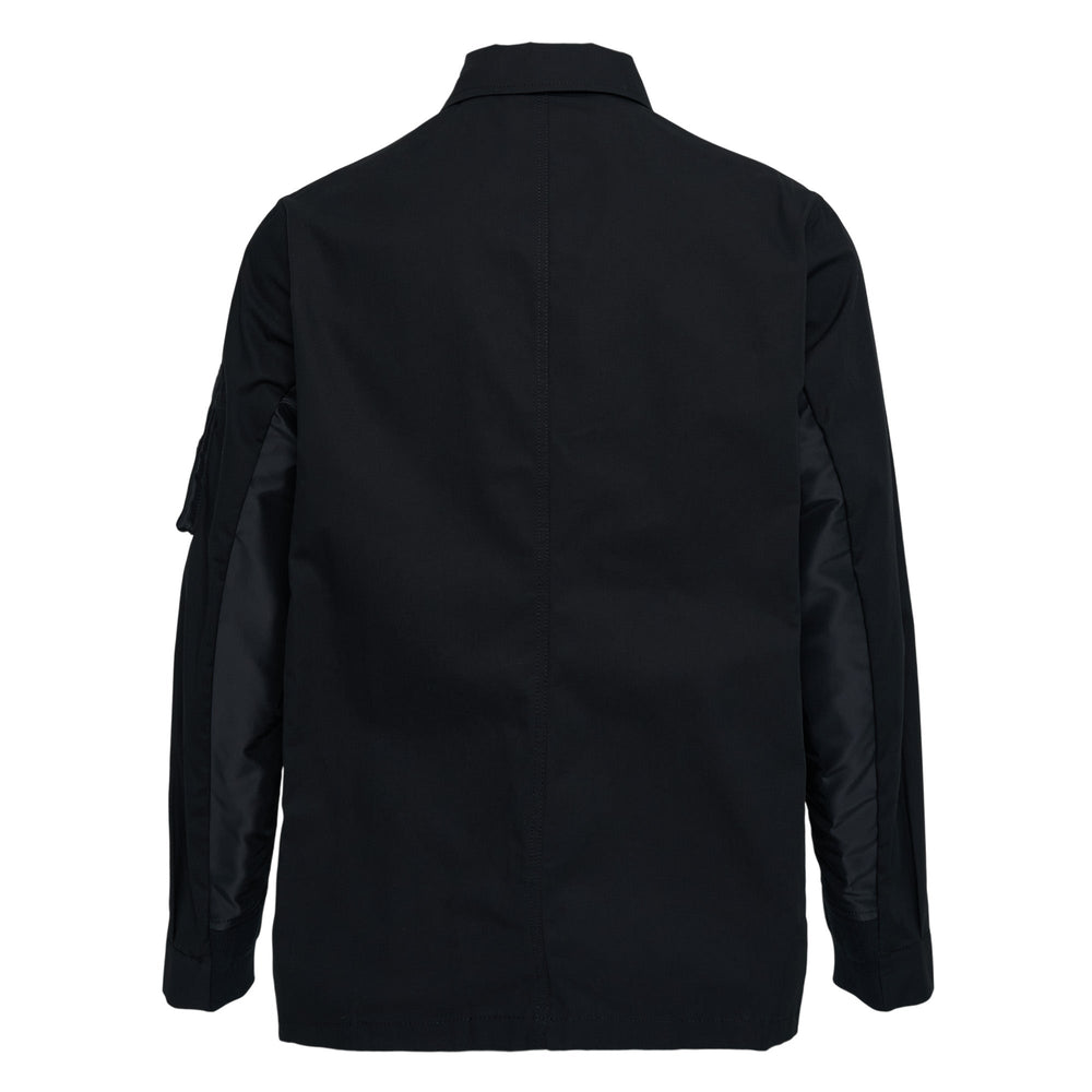 sacai Cotton Nylon Oxford Jacket in black, front view, featuring button-front closure, MA-1 nylon sleeve panel with zip pocket, and patch pockets