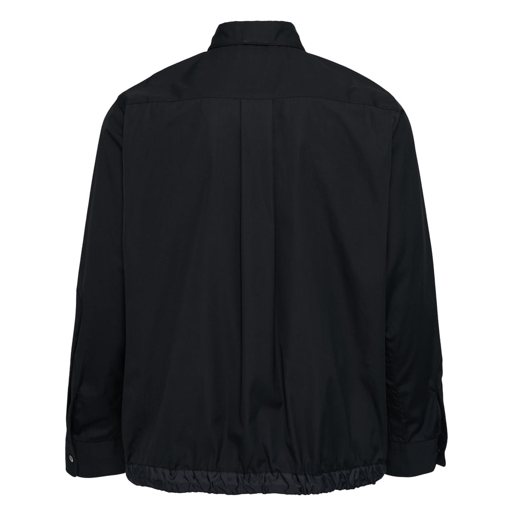 sacai Cotton Poplin Shirt in black with contrast nylon elasticated drawstring hem, silver-tone buttons, and chest patch pocket