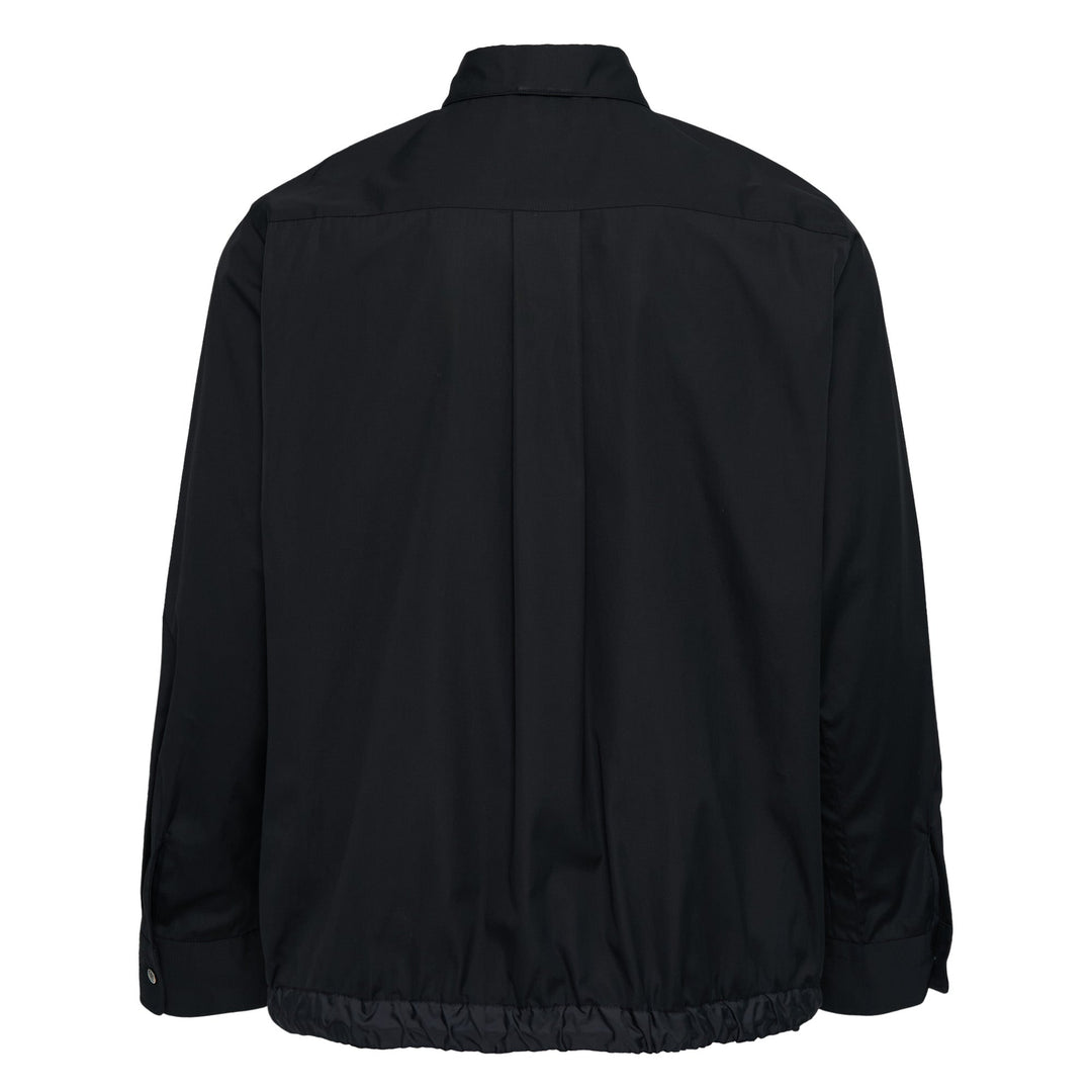 sacai Cotton Poplin Shirt in black with contrast nylon elasticated drawstring hem, silver-tone buttons, and chest patch pocket