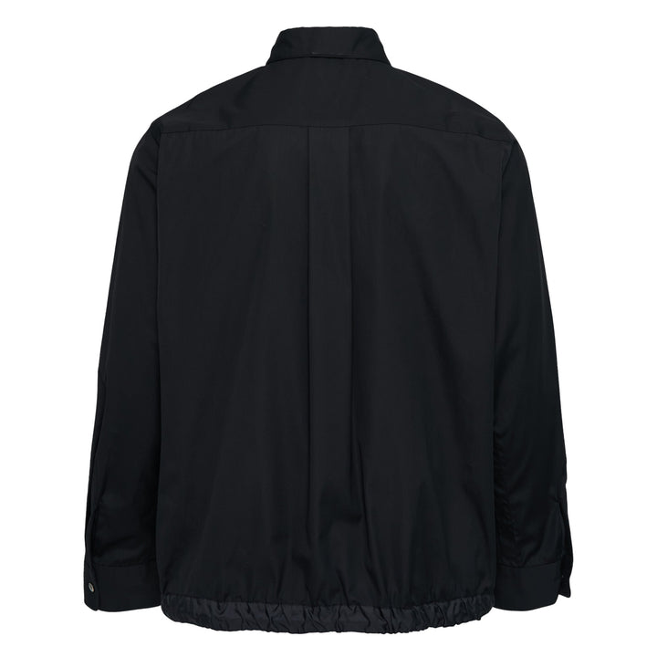 sacai Cotton Poplin Shirt in black with contrast nylon elasticated drawstring hem, silver-tone buttons, and chest patch pocket