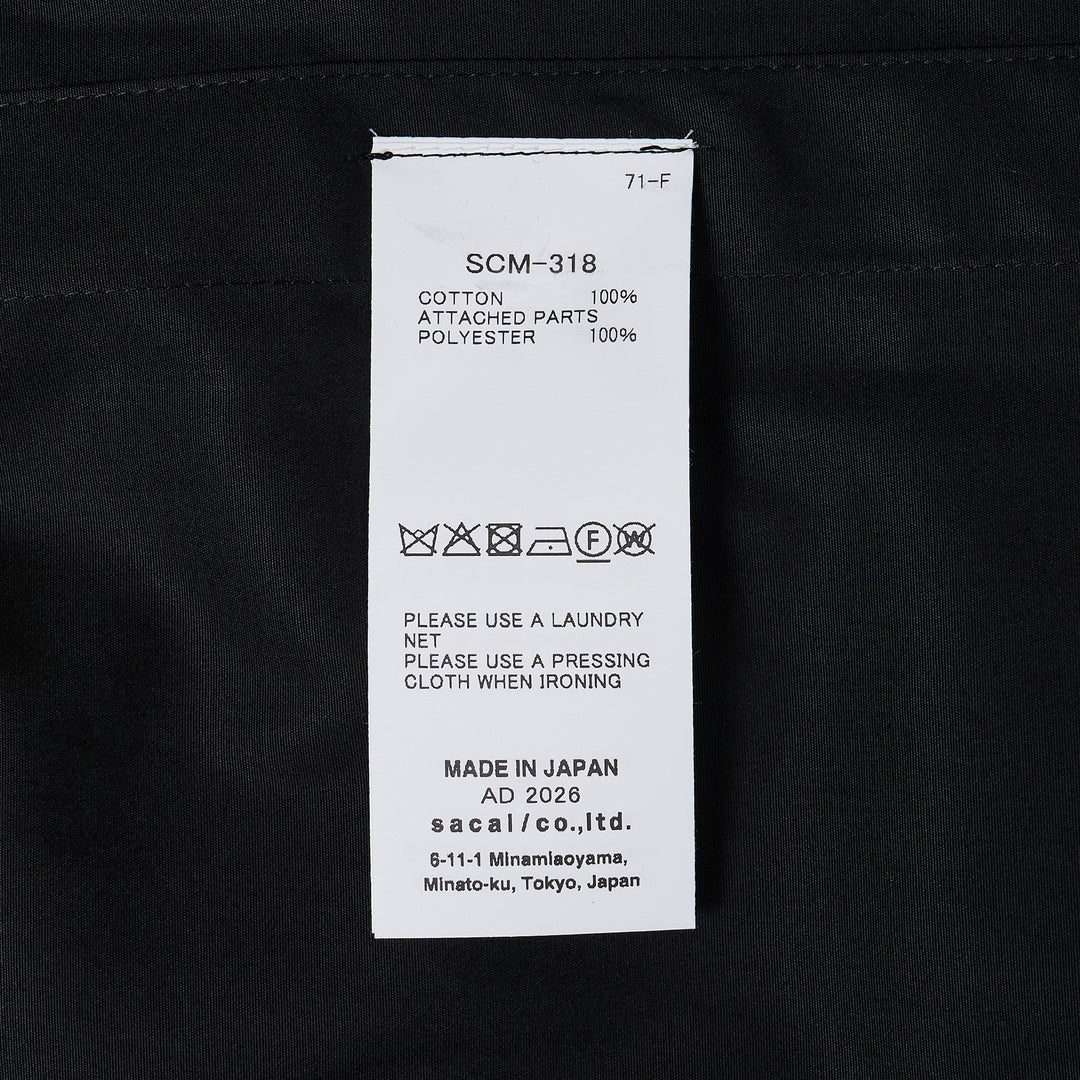 sacai Cotton Poplin Shirt in black with contrast nylon elasticated drawstring hem, silver-tone buttons, and chest patch pocket