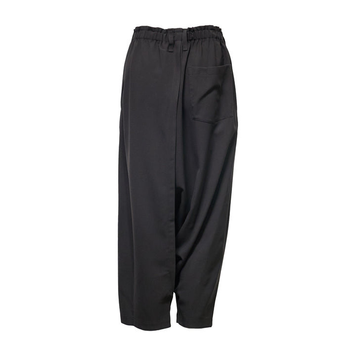 132 5. Issey Miyake black seamless woven drop crotch pants with elasticated drawstring waistband and cropped wide-leg silhouette