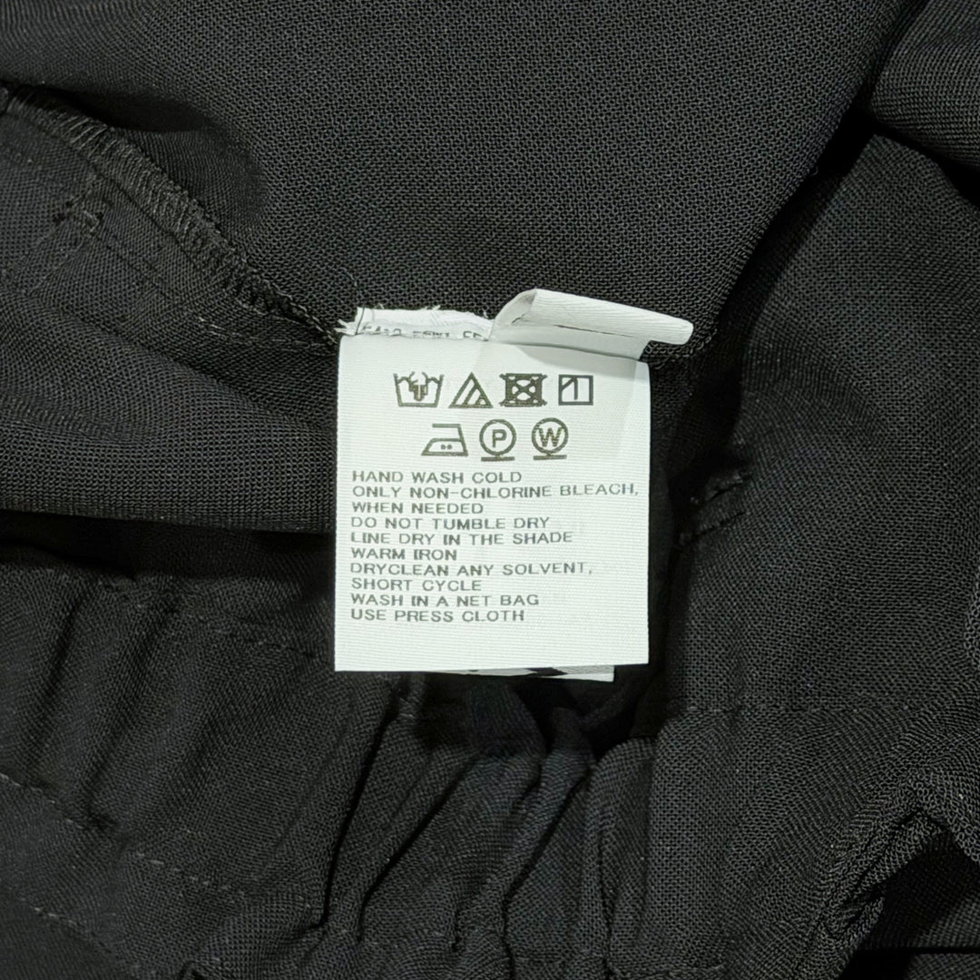 132 5. Issey Miyake black seamless woven drop crotch pants with elasticated drawstring waistband and cropped wide-leg silhouette
