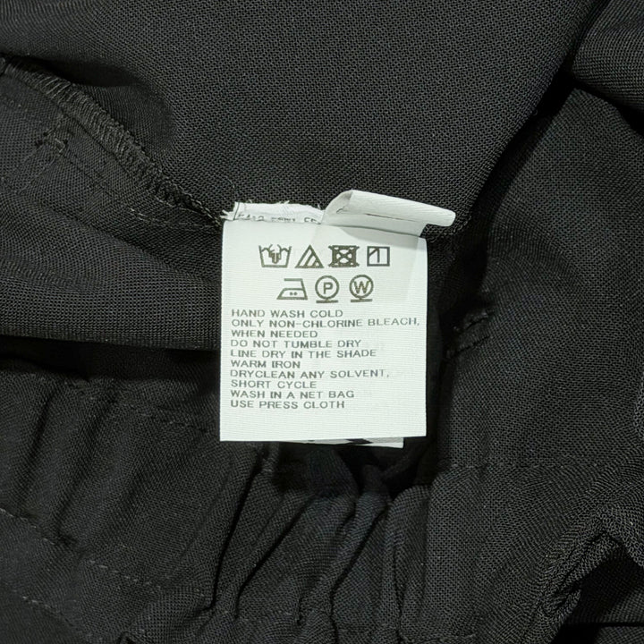 132 5. Issey Miyake black seamless woven drop crotch pants with elasticated drawstring waistband and cropped wide-leg silhouette