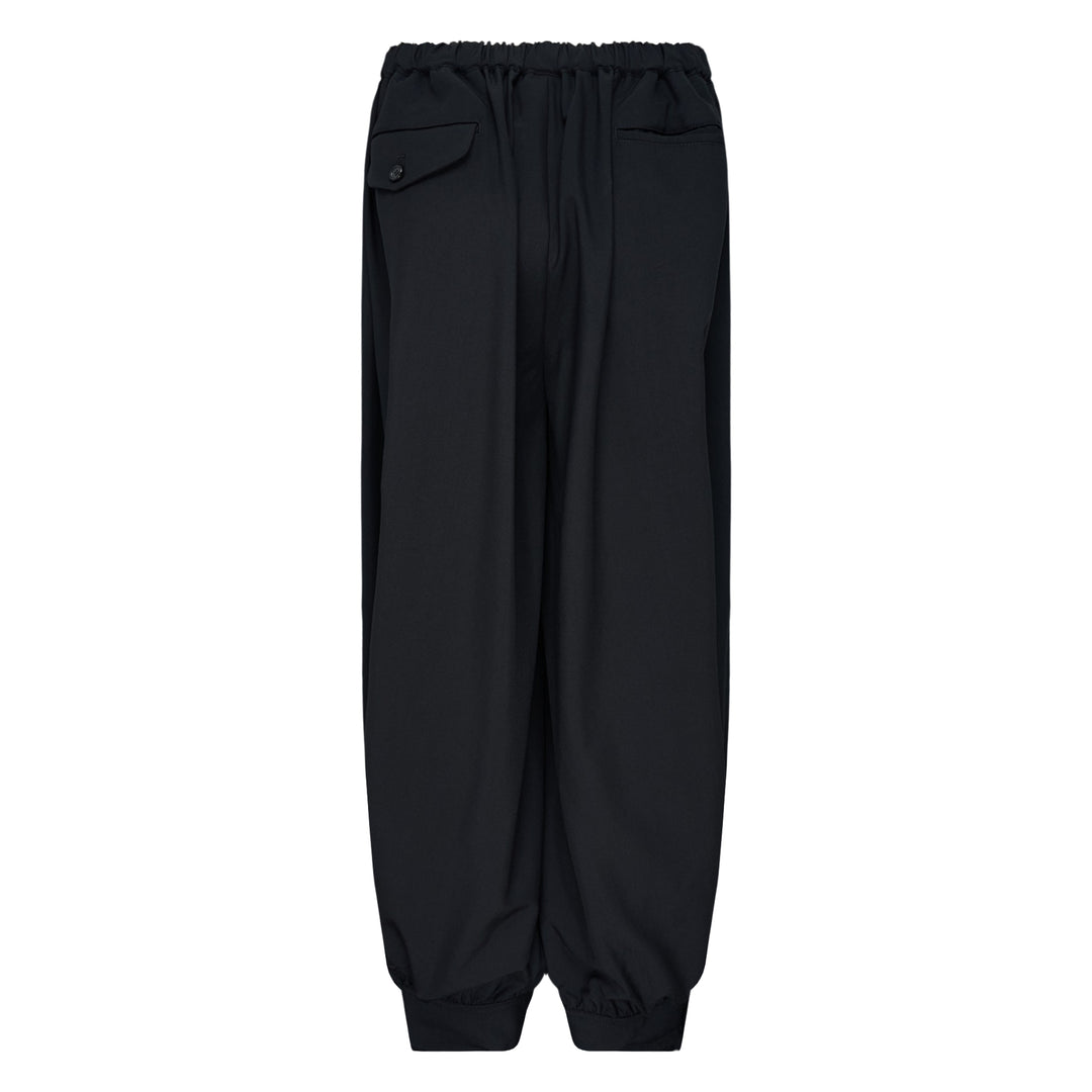 Comme des Garçons Black cuffed hem elastic waistband pants in black with wide-leg silhouette and elasticated ankles