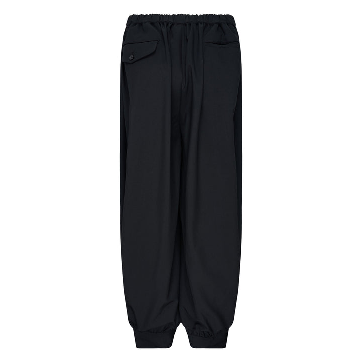 Comme des Garçons Black cuffed hem elastic waistband pants in black with wide-leg silhouette and elasticated ankles