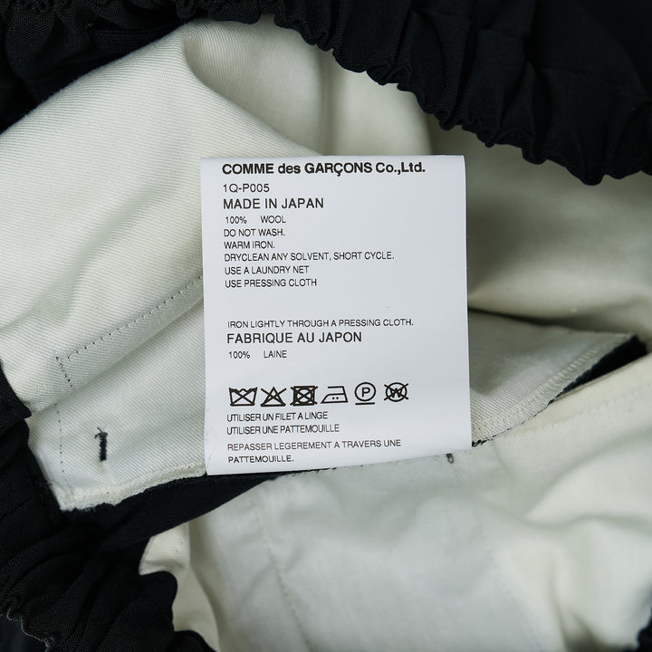 Comme des Garçons Black cuffed hem elastic waistband pants in black with wide-leg silhouette and elasticated ankles