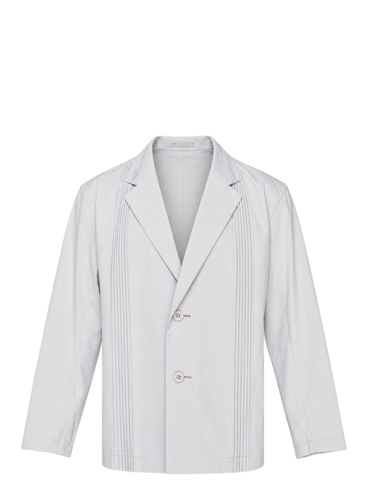 Pale grey IM Men Air Pleats jacket with notched lapels, vertical pleated panels and a two-button front, shown on a white background