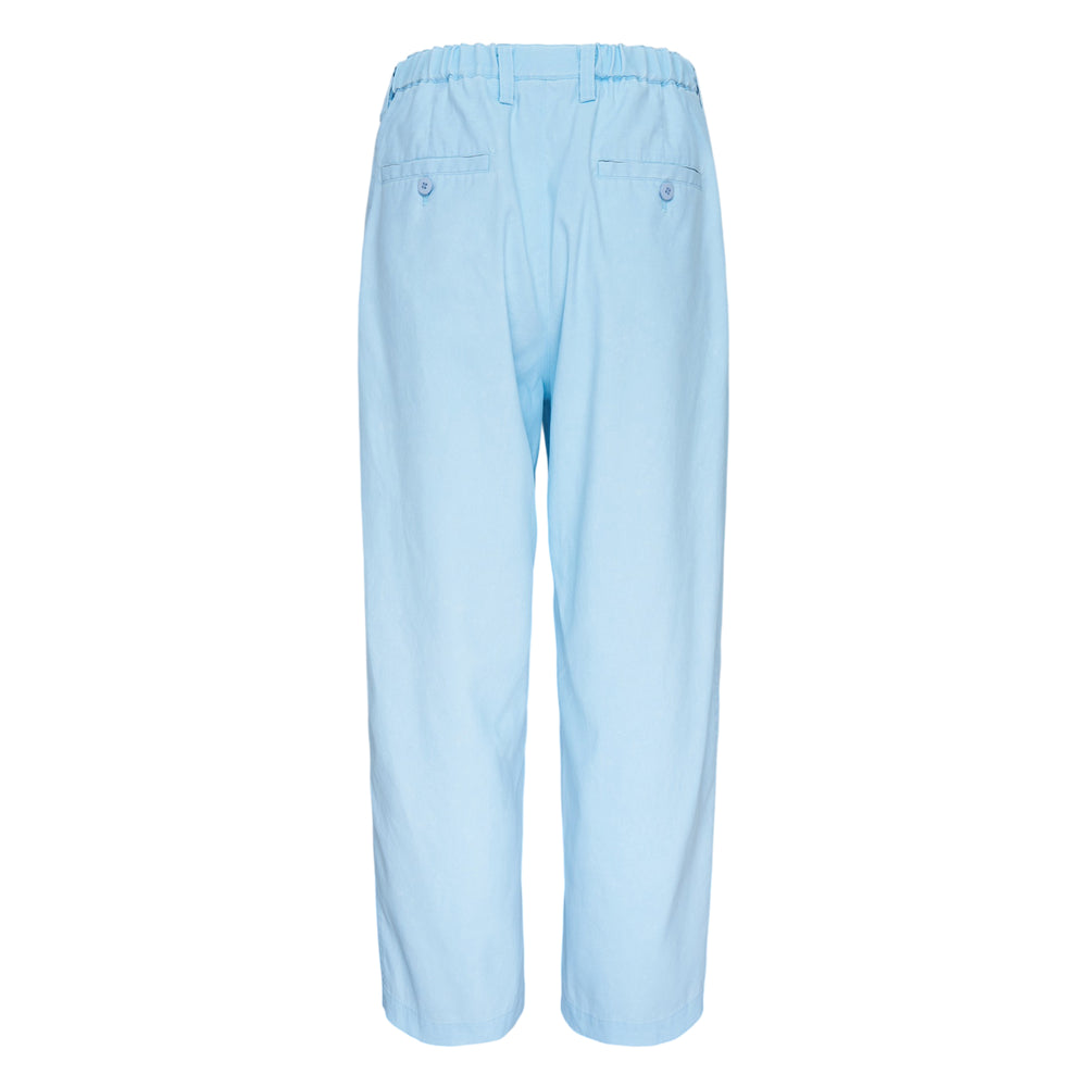 IM Men Air Wash Woven Pants in sky blue, featuring a relaxed tapered silhouette, elastic waistband with button tab, and vertical pintuck seam detailing