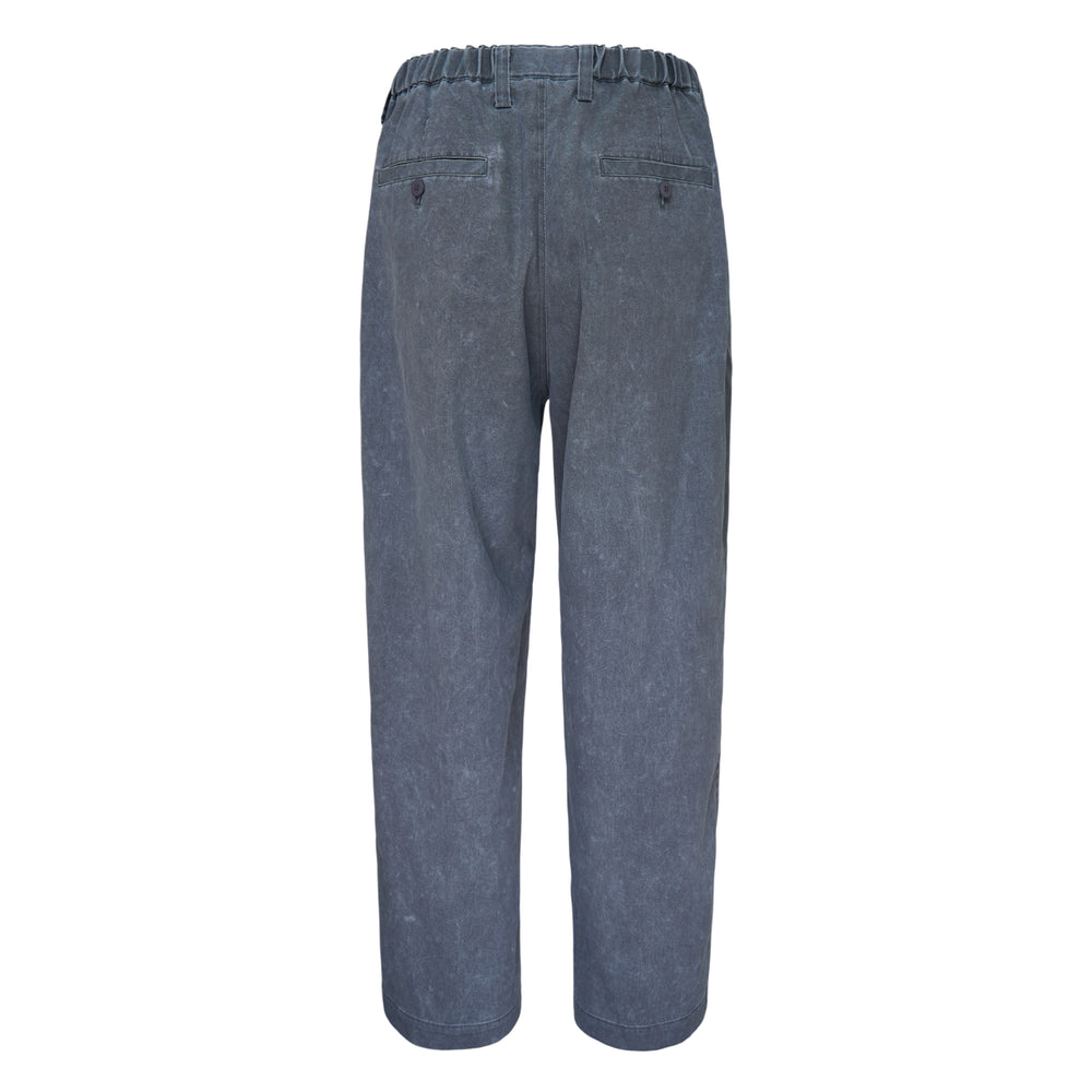 IM Men Air Wash Woven Pants in sky blue, featuring a relaxed tapered silhouette, elastic waistband with button tab, and vertical pintuck seam detailing