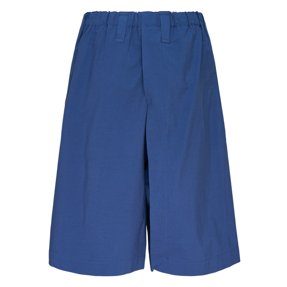 IM MEN Navy Bottoms — wide-leg shorts in deep blue with elasticated waistband, belt loops, utility patch pocket, and rolled hem cuffs
