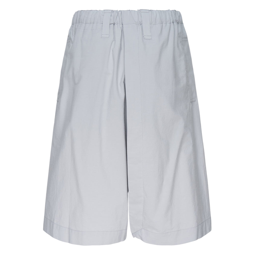 IM MEN Navy Bottoms — wide-leg shorts in deep blue with elasticated waistband, belt loops, utility patch pocket, and rolled hem cuffs