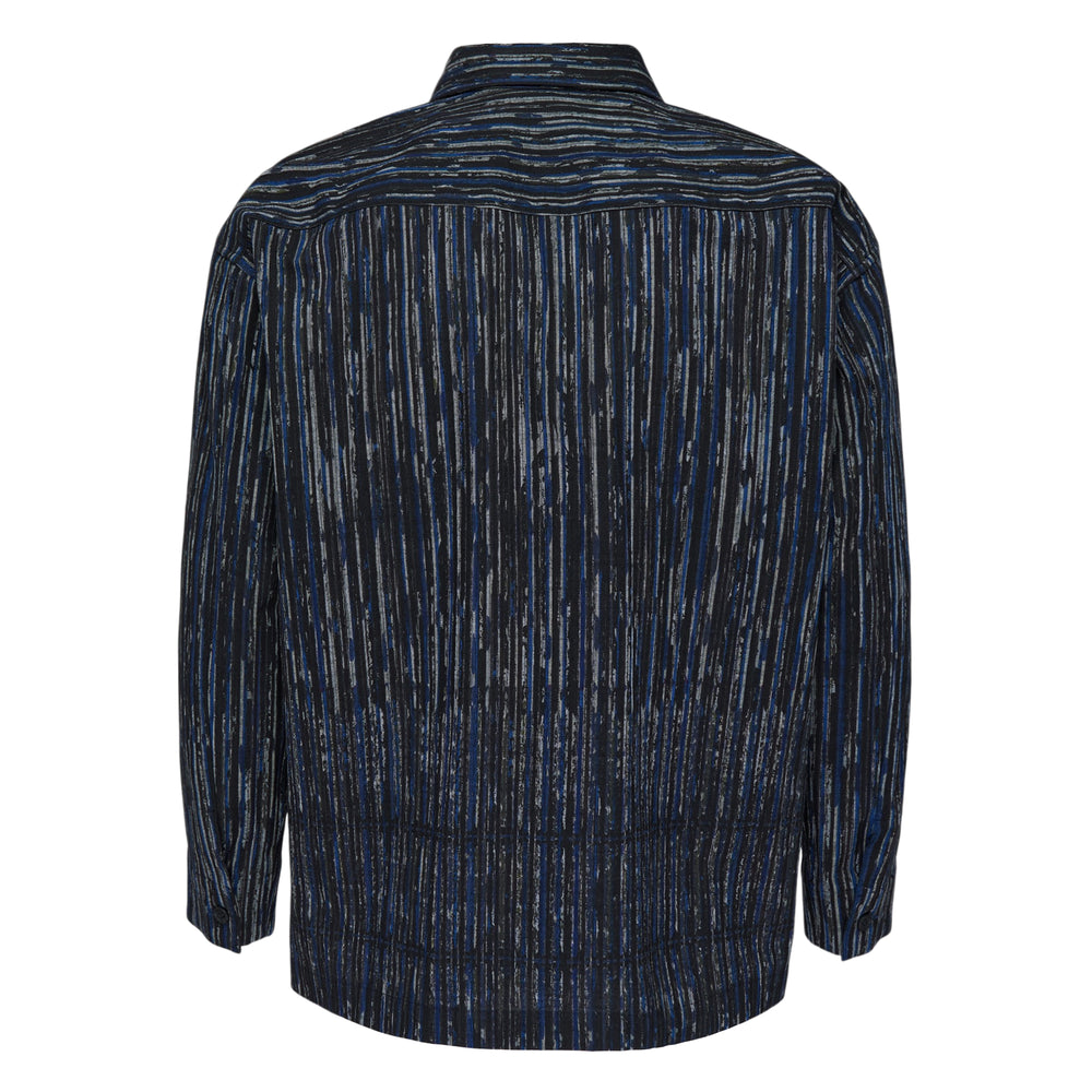 IM MEN Curviness Long Sleeve Shirt in a painterly vertical stripe print of blue, white, and khaki tones with brown buttons and a relaxed overshirt silhouette