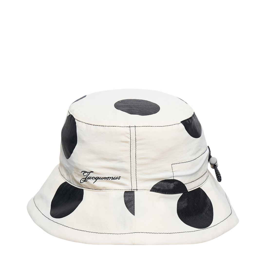 Jacquemus Le Bob Baluchon bucket hat in off-white with large black polka dots, featuring a wide brim with contrast topstitching and script logo detail - view 2