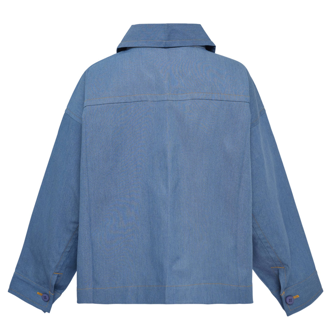 me Issey Miyake Flat Denim Jacket in light blue with purple buttons and contrast gold topstitching, flat lay front view