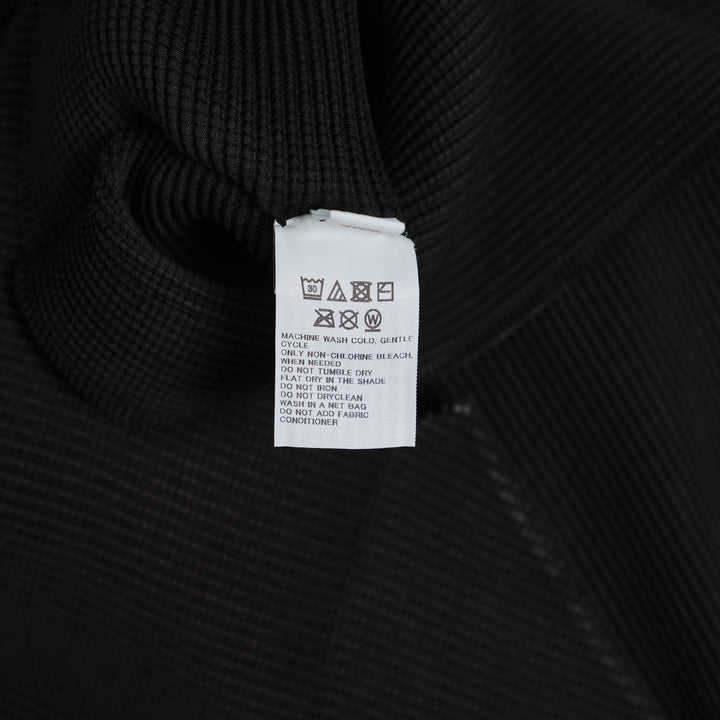 me Issey Miyake Stretch Pleats High Neck Top in black with short sleeves and structured turtleneck collar, flat lay on white background