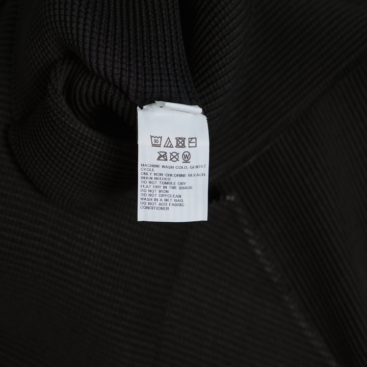 me Issey Miyake Stretch Pleats Round Neck Top in black, featuring all-over micro-pleating and short sleeves on a white background