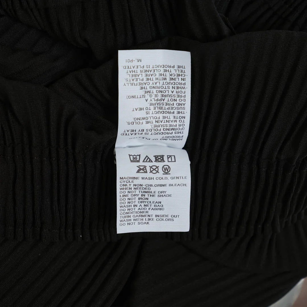 me Issey Miyake Fine Knit Pleated Wide Pants in black with elastic waistband and wide-leg silhouette, front view