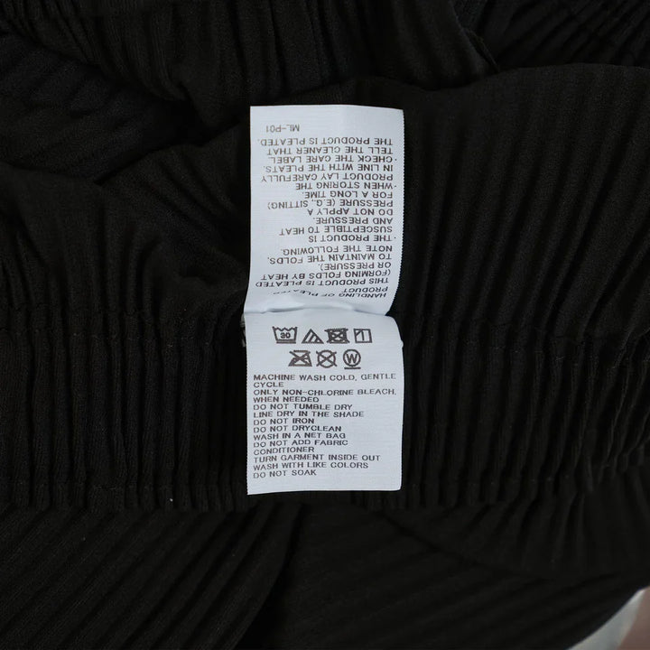 me Issey Miyake Fine Knit Pleated Wide Pants in black with elastic waistband and wide-leg silhouette, front view