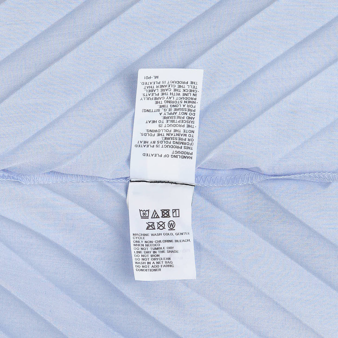 me Issey Miyake Angle Pleats Sleeveless Top in light grey with diagonal pleating and asymmetric hem, viewed from the front