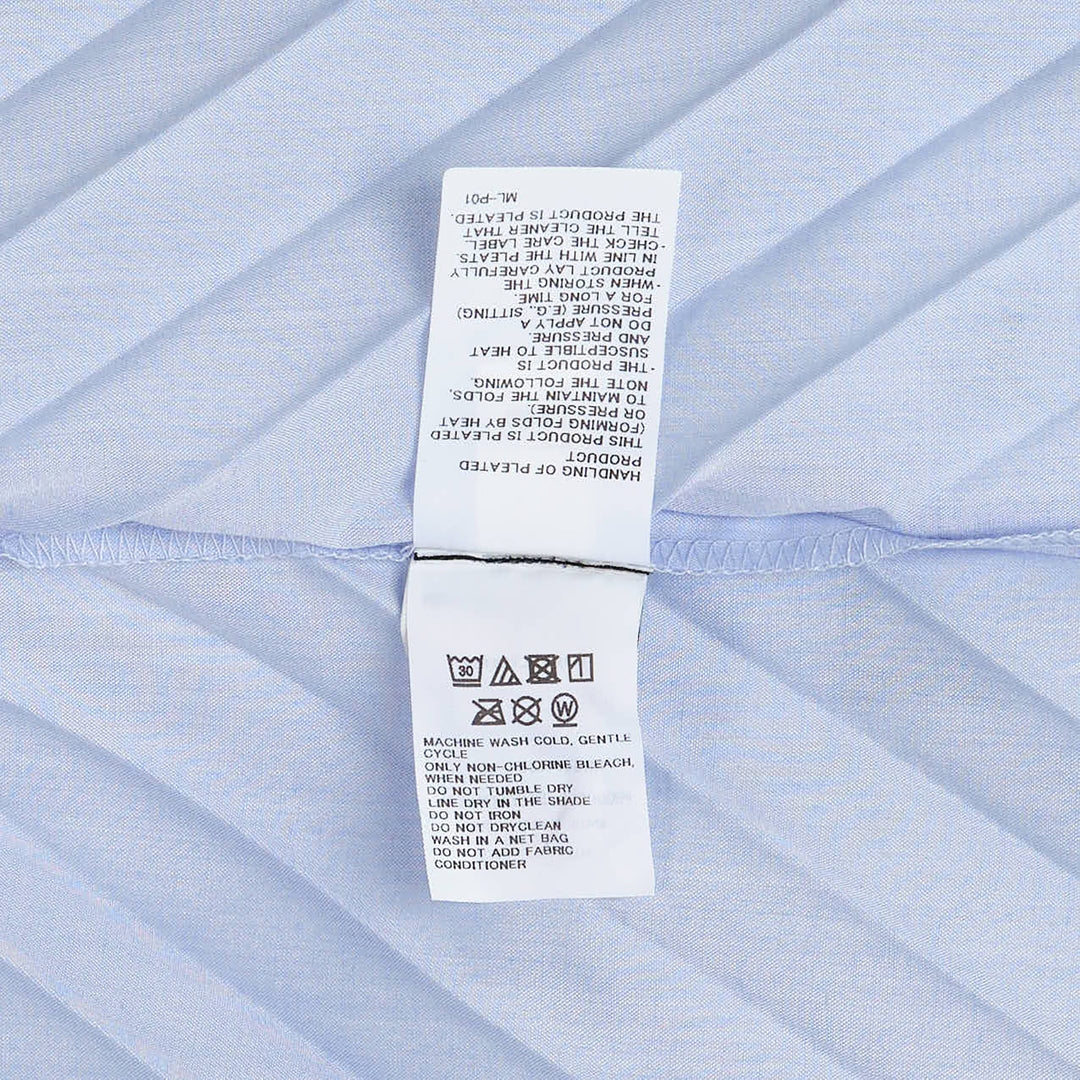 me Issey Miyake Angle Pleats short sleeve button-front collared shirt in light grey with diagonal pleating and asymmetric draped hem