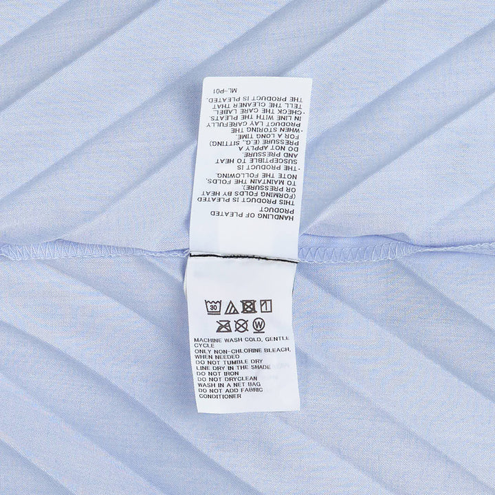 me Issey Miyake Angle Pleats short sleeve button-front collared shirt in light grey with diagonal pleating and asymmetric draped hem