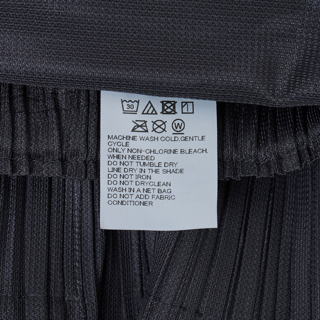 Pleats Please Issey Miyake Fluffy Basics Pleated Pants in charcoal grey with vertical pleating, relaxed harem silhouette, elasticated waist and cuffs