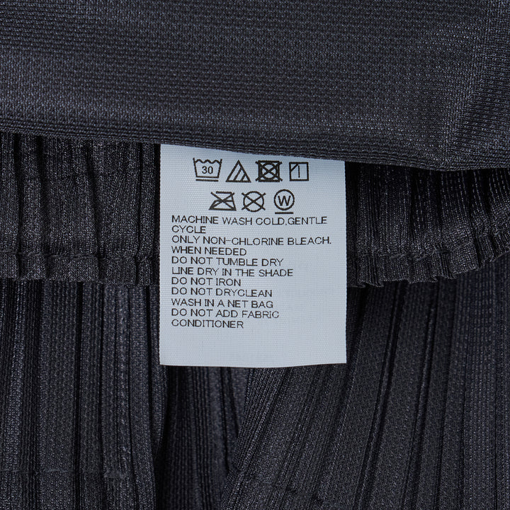 Pleats Please Issey Miyake Fluffy Basics Pleated Pants in charcoal grey with vertical pleating, relaxed harem silhouette, elasticated waist and cuffs