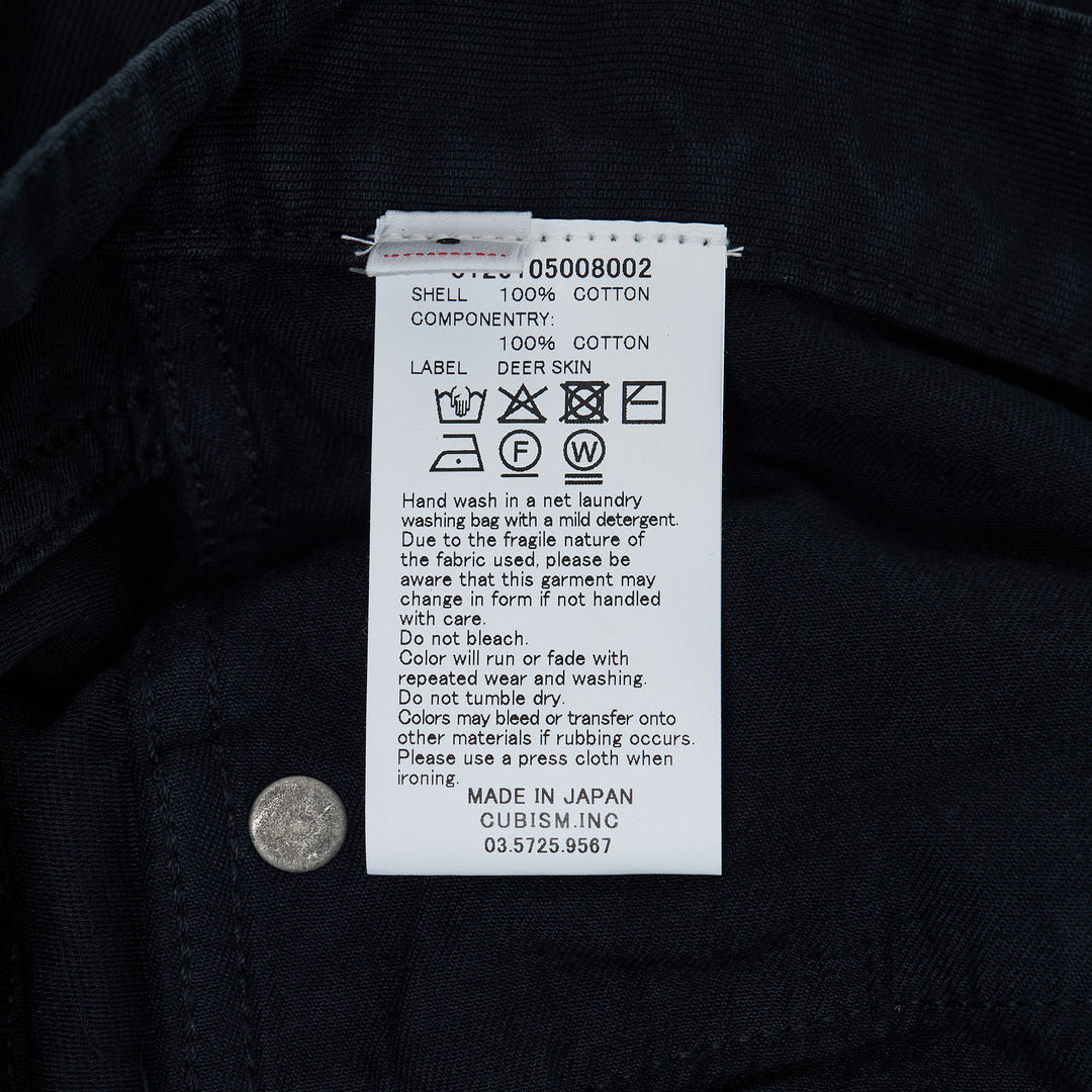 visvim Fluxus 03 G.Cords corduroy pants in deep navy with a relaxed straight fit and silver-tone hardware, front view on white background