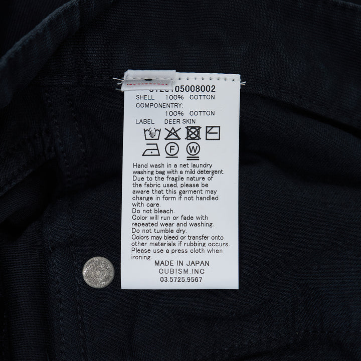 visvim Fluxus 03 G.Cords corduroy pants in deep navy with a relaxed straight fit and silver-tone hardware, front view on white background