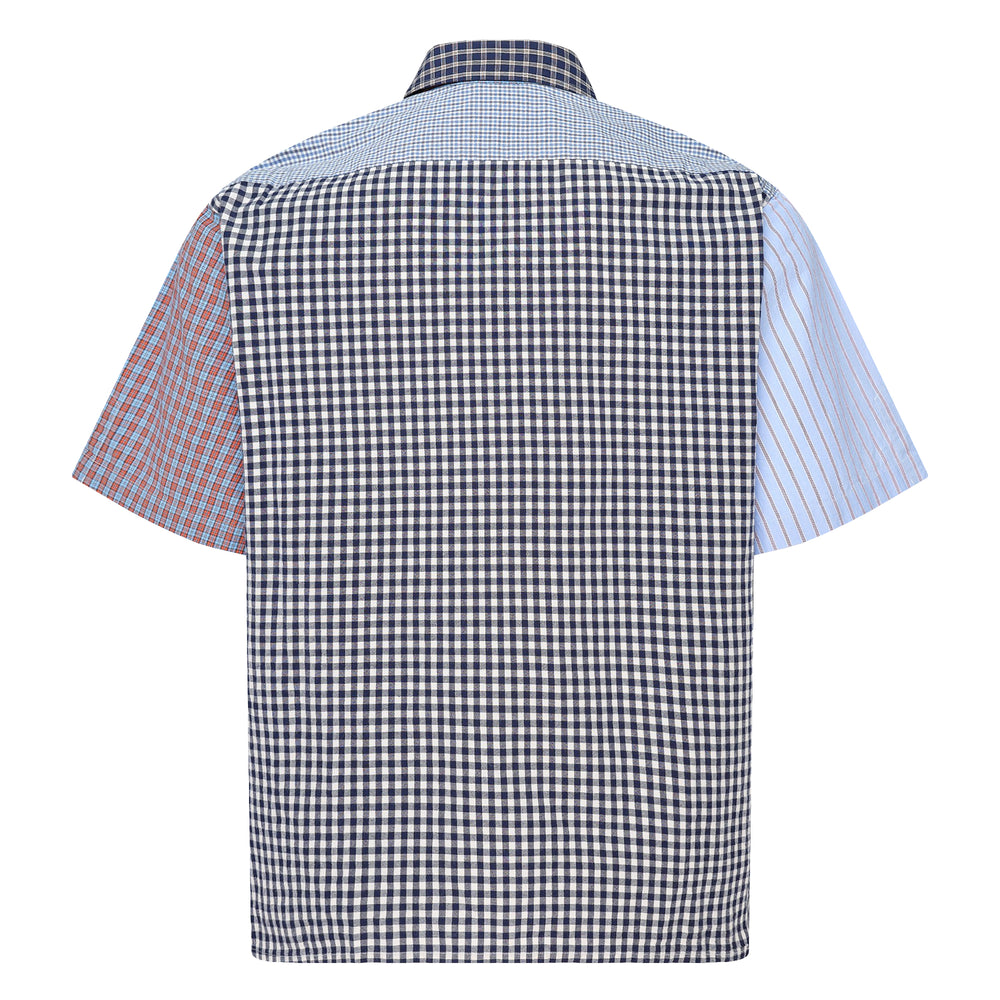 Human Made Crazy Check Short Sleeve Shirt featuring patchwork multi-check and plaid panels in green, yellow, blue, and navy, with contrast chest pockets and an embroidered heart logo patch