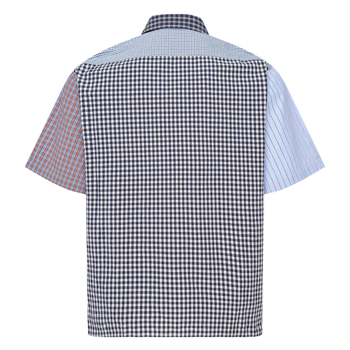 Human Made Crazy Check Short Sleeve Shirt featuring patchwork multi-check and plaid panels in green, yellow, blue, and navy, with contrast chest pockets and an embroidered heart logo patch