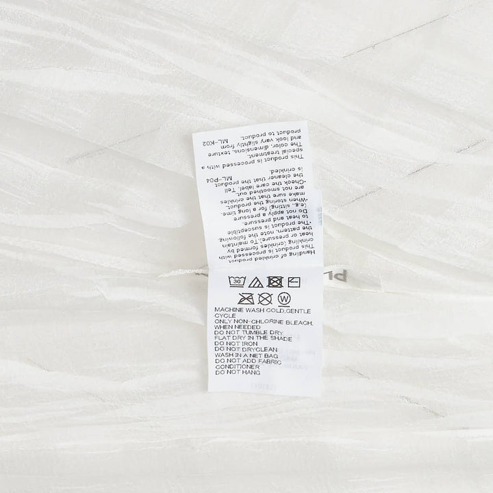 Pleats Please Issey Miyake Twisted Border Shirt in white with all-over crinkled pleat texture, relaxed boxy fit, short sleeves and rounded neckline