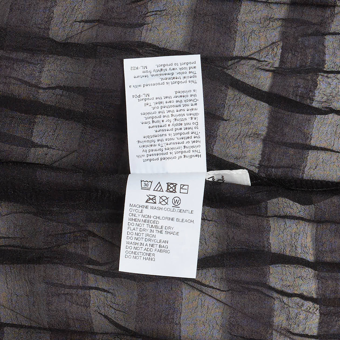 Pleats Please Issey Miyake Twisted Border Shirt in sheer black pleated fabric with horizontal stripe pattern and short sleeves, flat lay front view