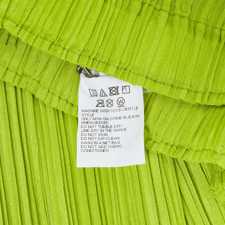 Pleats Please Issey Miyake Mellow Pleats Pants in black, featuring a wide-leg silhouette, fine vertical pleating, and an elasticated waistband, displayed flat on a white background.
