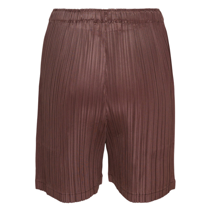 Pleats Please Issey Miyake Loop Pleated Shorts in cream with vertical micro-pleating and elasticated waistband, front view on white background