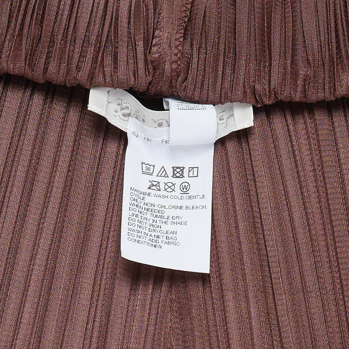 Pleats Please Issey Miyake Loop Pleated Shorts in cream with vertical micro-pleating and elasticated waistband, front view on white background