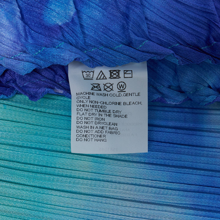 Pleats Please Issey Miyake Sea Bubble Skirt in cobalt blue and aqua watercolor pleated fabric with smocked elastic waistband and midi A-line silhouette