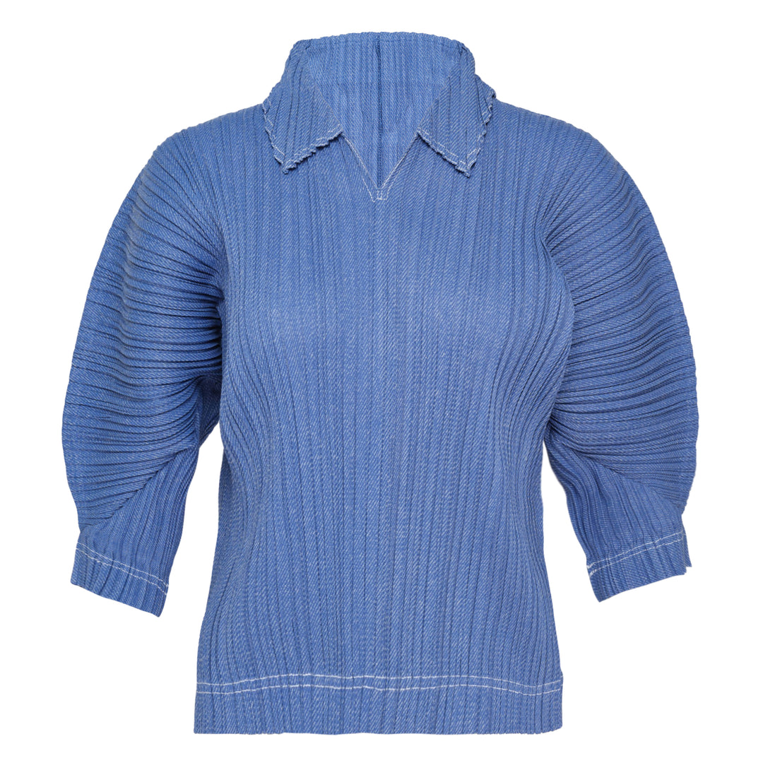 Pleats Please Issey Miyake Cotton Denim pleated top in indigo blue, featuring a notched mock neck, elbow-length sleeves, all-over vertical pleating, and contrast hem stitching — front view on white background
