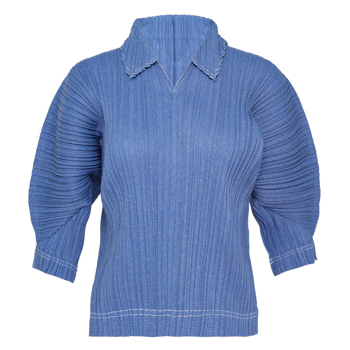 Pleats Please Issey Miyake Cotton Denim pleated top in indigo blue, featuring a notched mock neck, elbow-length sleeves, all-over vertical pleating, and contrast hem stitching — front view on white background