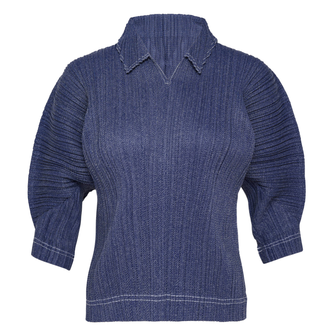 Pleats Please Issey Miyake Cotton Denim pleated top in indigo blue, featuring a notched mock neck, elbow-length sleeves, all-over vertical pleating, and contrast hem stitching — front view on white background